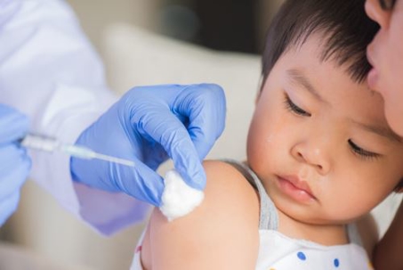 doctor giving child a vaccine